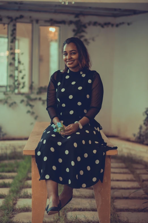 the woman is smiling while sitting on a bench