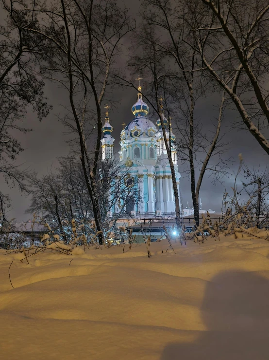 a very tall church surrounded by some trees