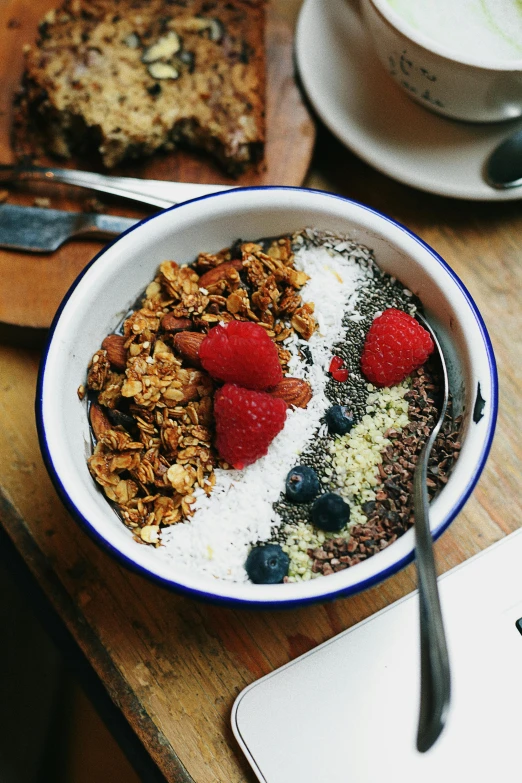 this is a bowl of oatmeal with fruit and granola