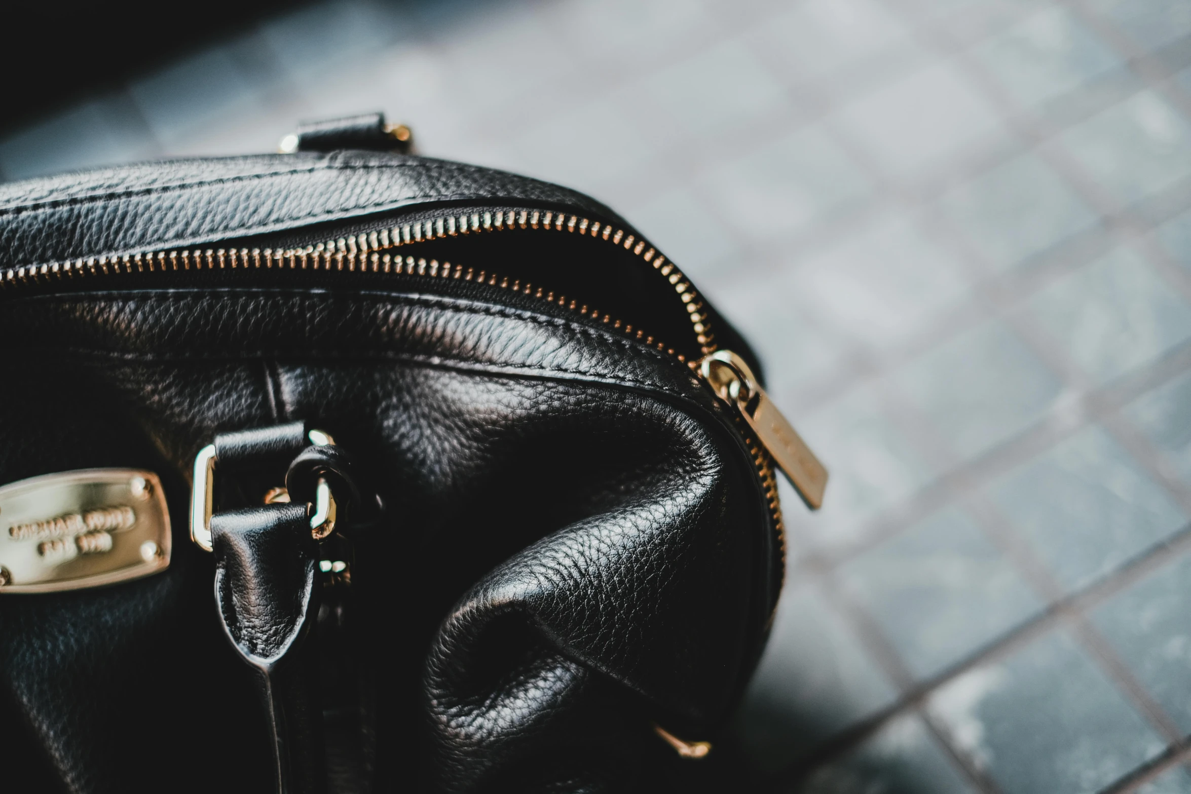 there is a zipper in a black leather handbag