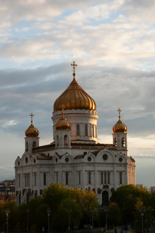 a large white building with two golden domes