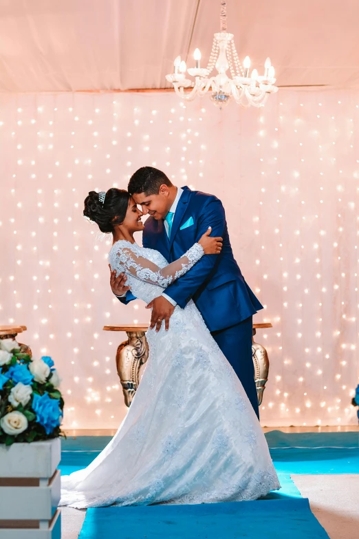 the newlywed couple is posing for pictures in front of an illuminated room