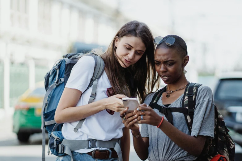 two women looking at soing on the phone