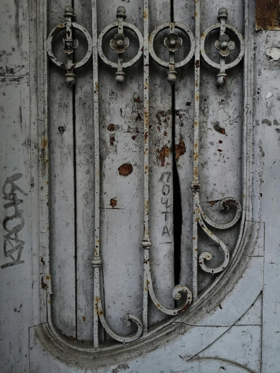 a door with a rusty metal design, and a set of s