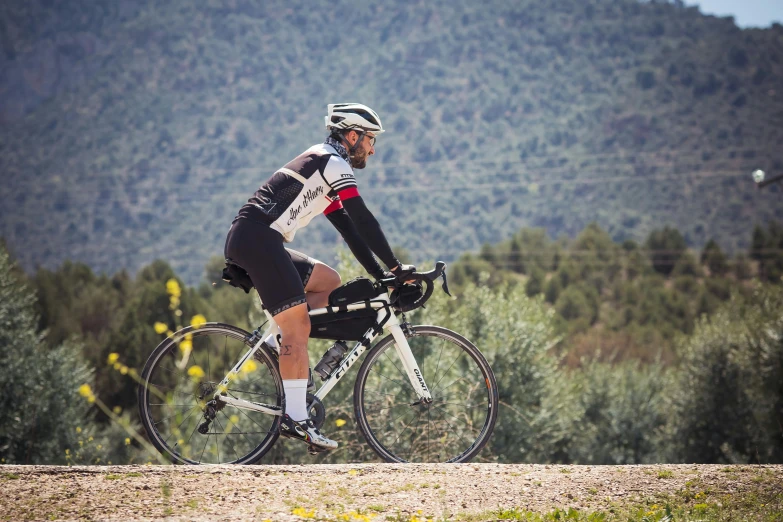 the cyclist is riding on his bike in a field