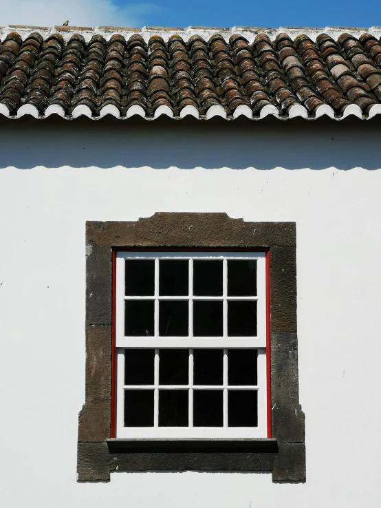 the bottom half of a window with red trim on it