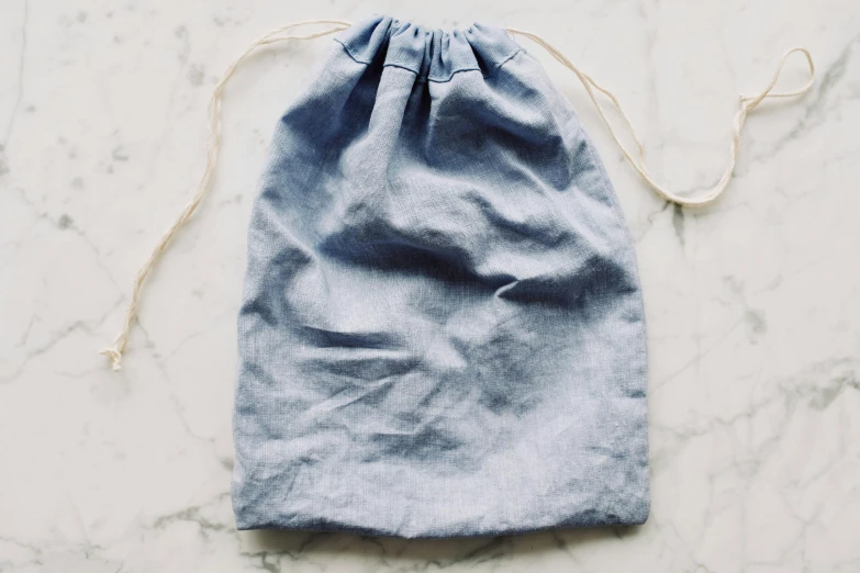 a drawstring bag sitting on top of a table