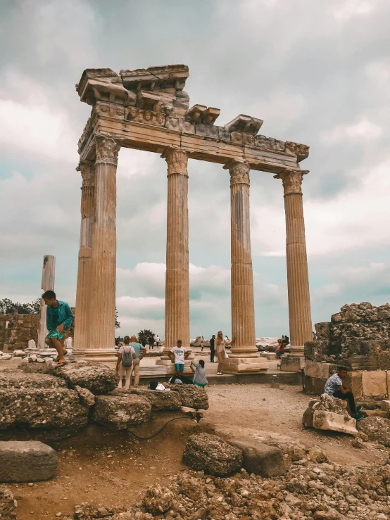 the ruins and tourists are near some pillars