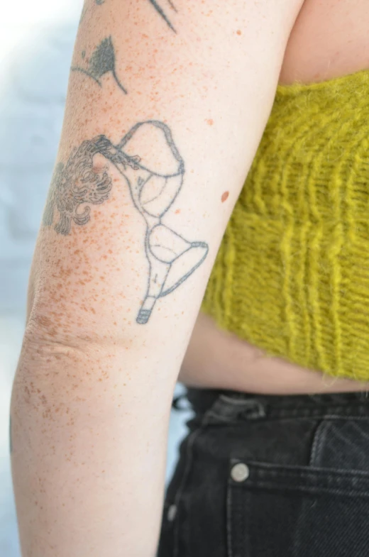 a girl with a tattoo on her arm