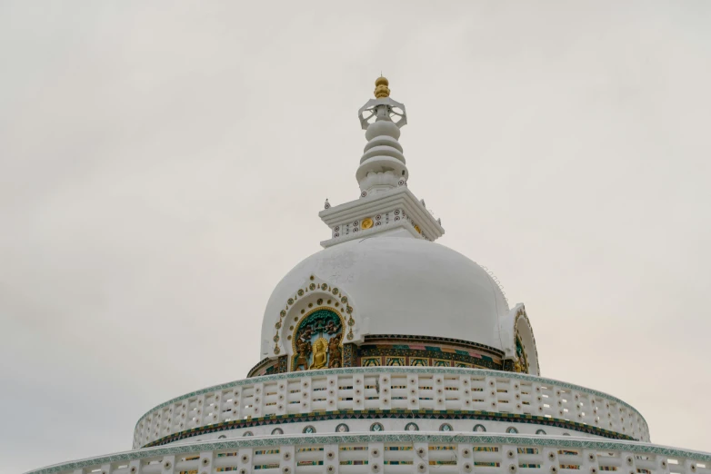 a large white dome that is under a cloudy sky