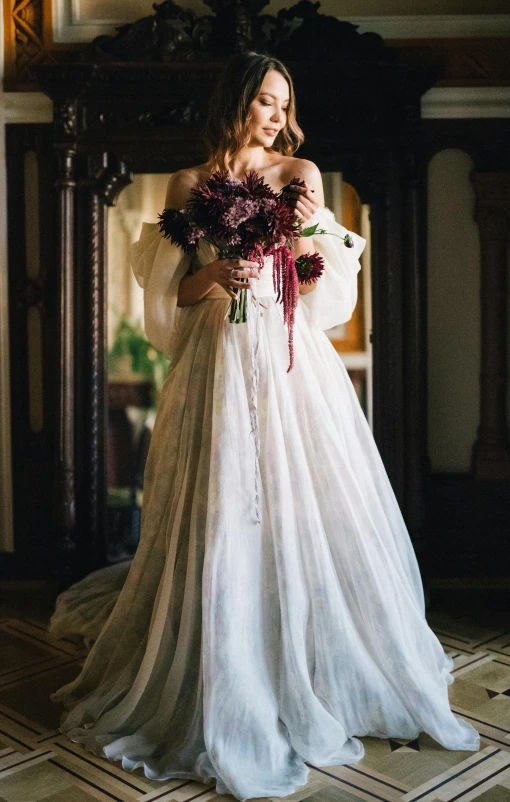 the bride holds her bouquet of flowers