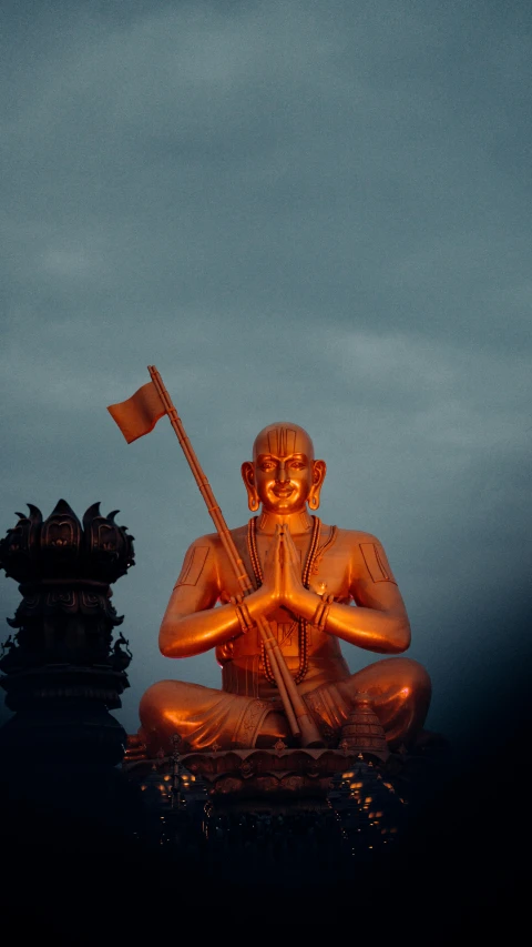 a buddha statue sits with a flag