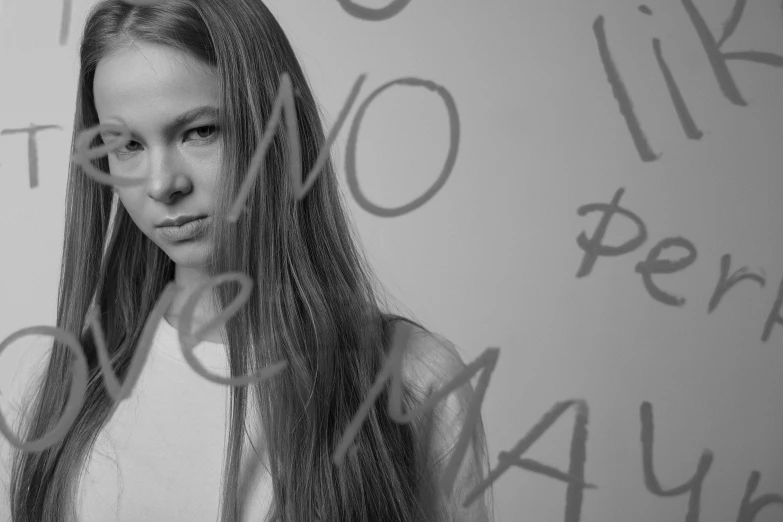 a beautiful young lady standing behind an advertit sign