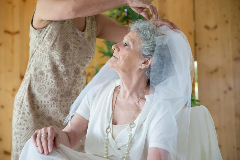 an older woman getting ready for her wedding ceremony