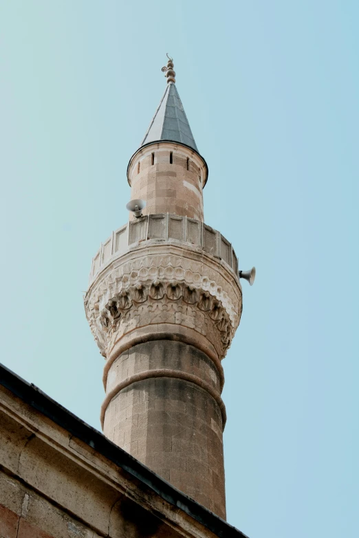 a large stone tower with a blue sky background