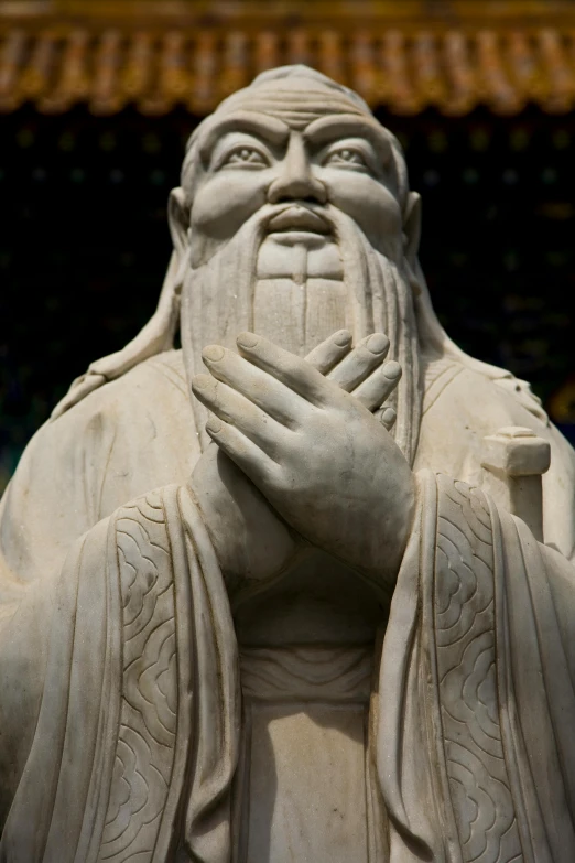 a close up of an interesting sculpture with hands over his face