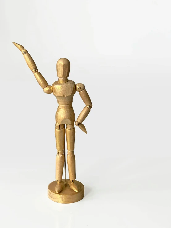 wooden statue holding a pointing up a large knife