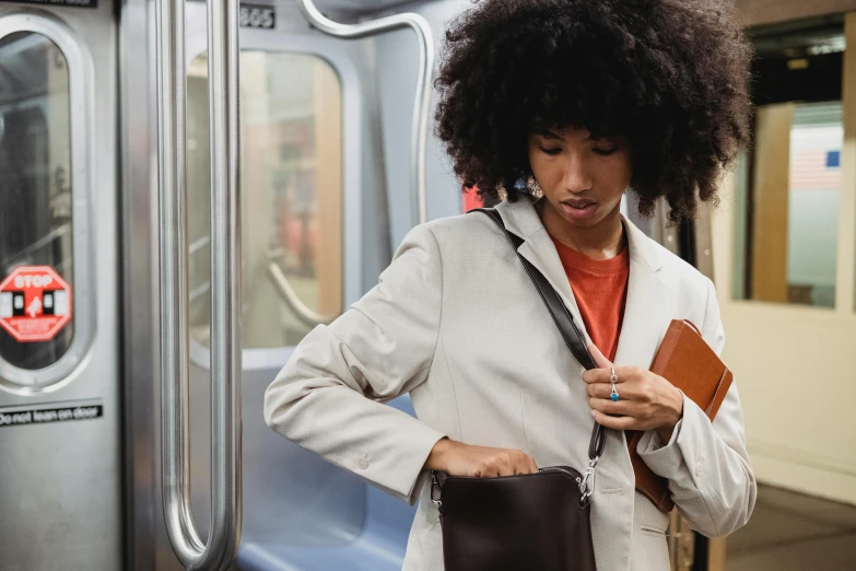 the woman is standing on the subway platform