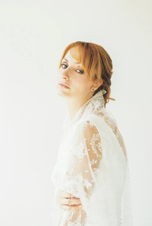 a woman in a white blouse is standing up