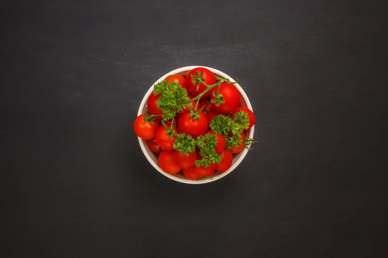 a bowl of tomatoes on the table