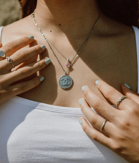 a person with rings on their hands wearing a shirt