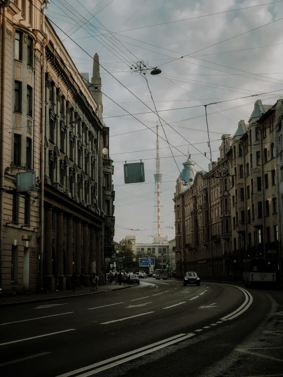 an empty street and traffic lights with buildings in the background