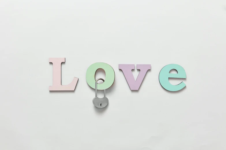 letters in pastel blue, white and pink hanging from hooks