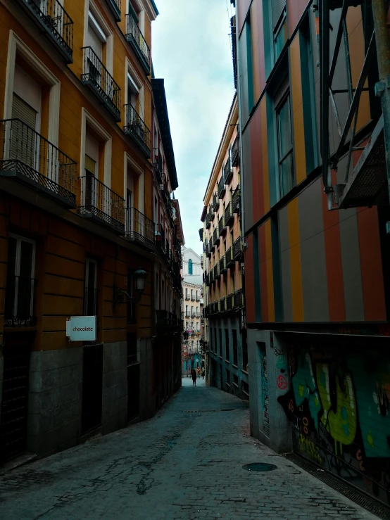 the building has graffiti on it and another part has other buildings