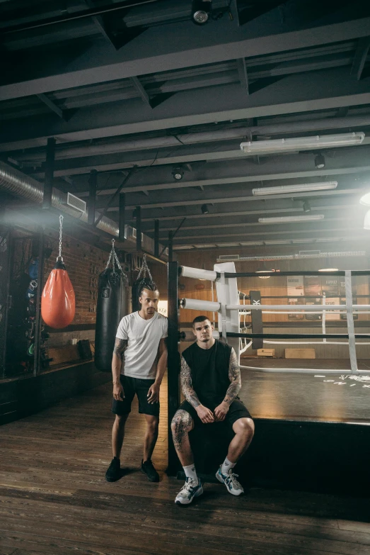 two men standing next to each other in a boxing ring