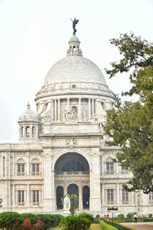 a view of a stone building with a statue on top