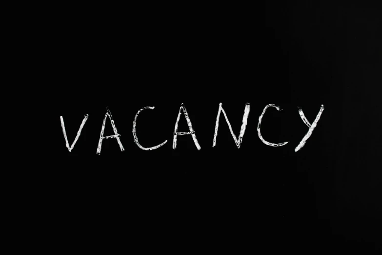 a black background with the word vacancy written in white chalk