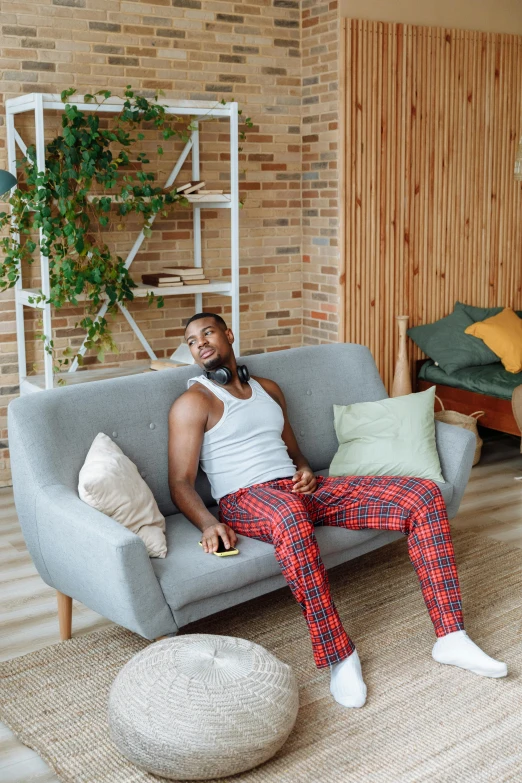 a man sitting on a couch with a smile on his face