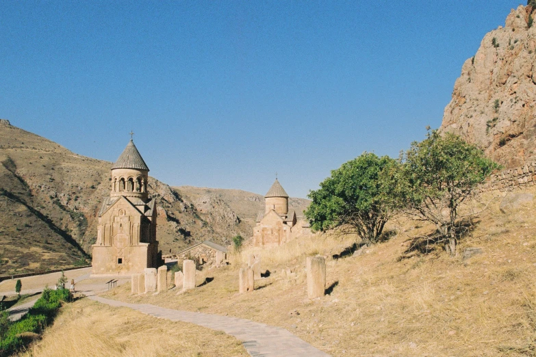 an old church sitting on the side of a hill