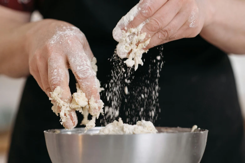 a chef kneads flour onto his mixer