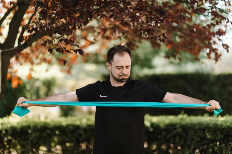 a man that is holding up a large blue ribbon