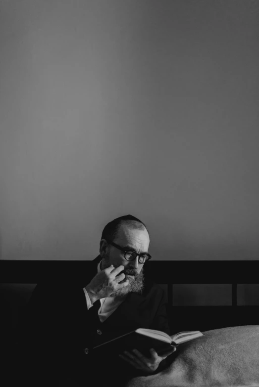 a man is sitting on a bed and smoking