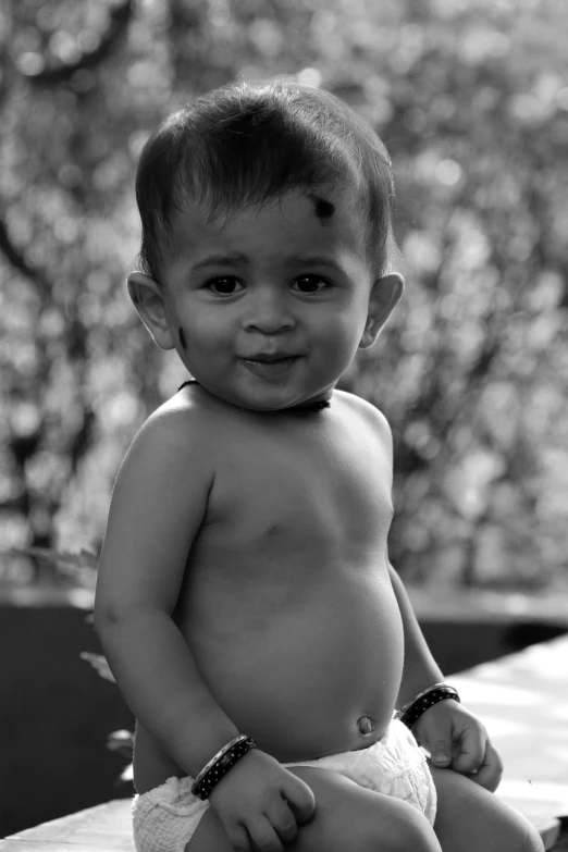 a small child is sitting on a bench