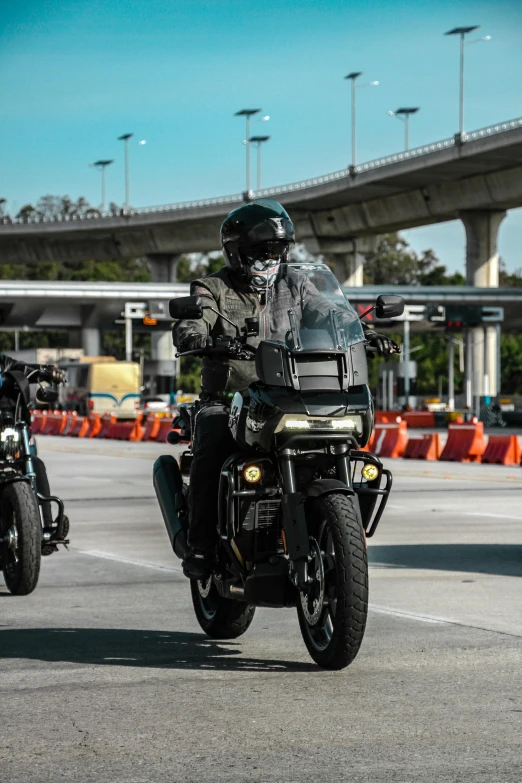 two men ride their motorcycles down the road