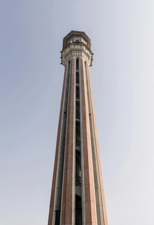 a tall tower is shown with some clocks