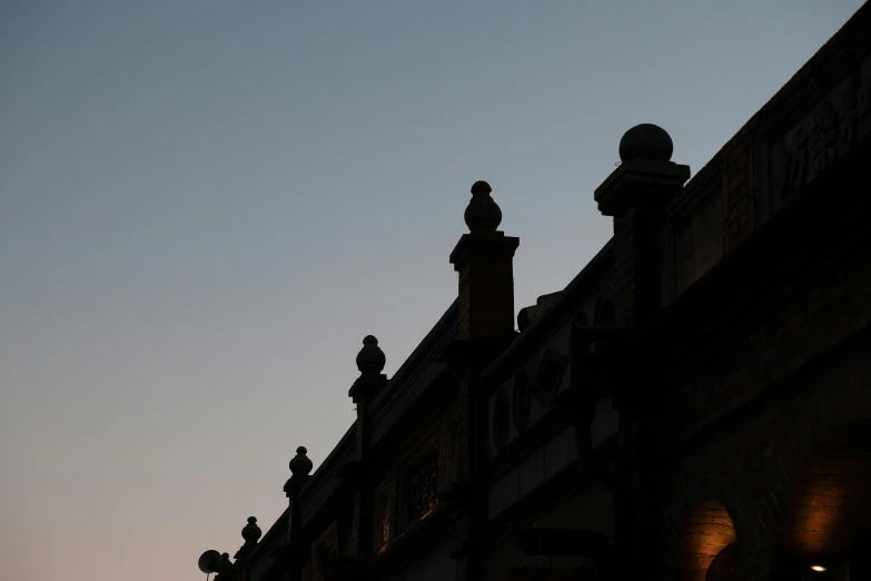 a silhouette of an old building with some towers