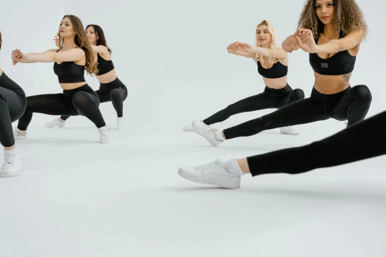 two women with sports clothes are jumping in the air