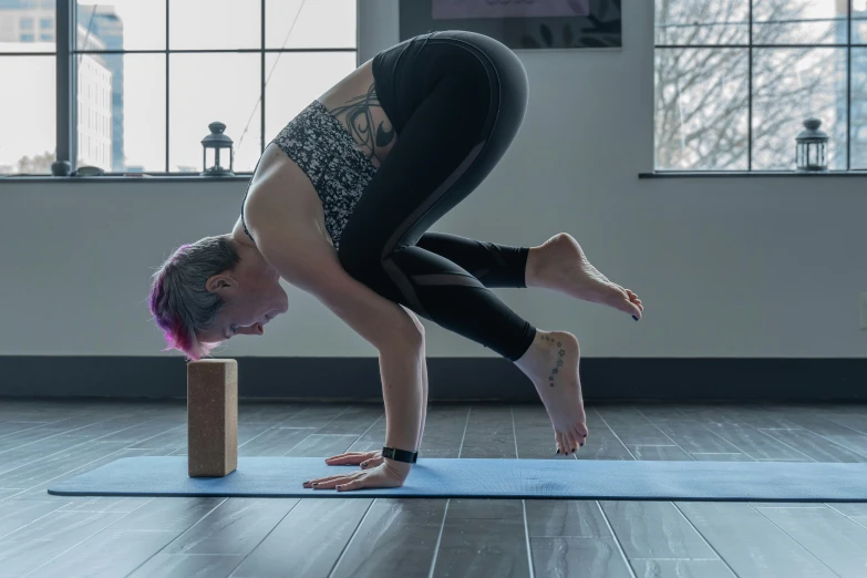 woman does an upside down yoga pose in the middle of a room