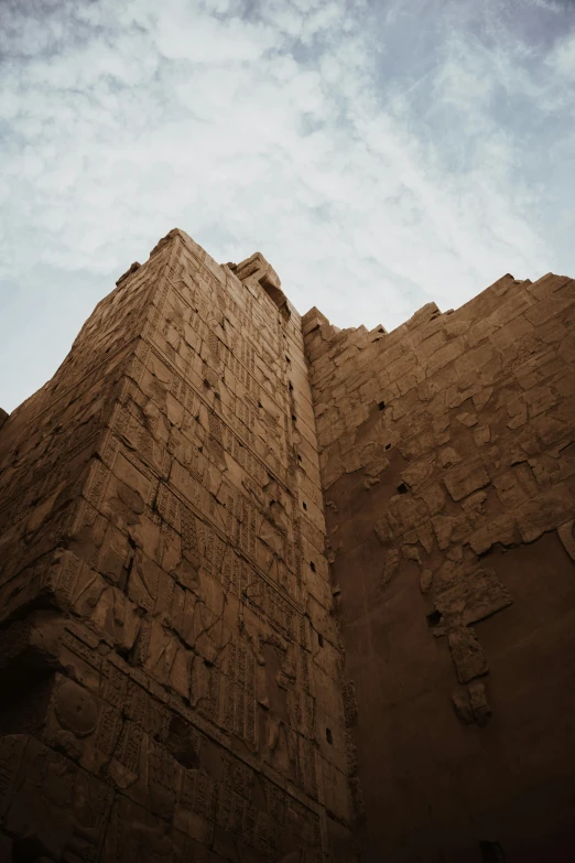 an old brick building that has been placed against the sky