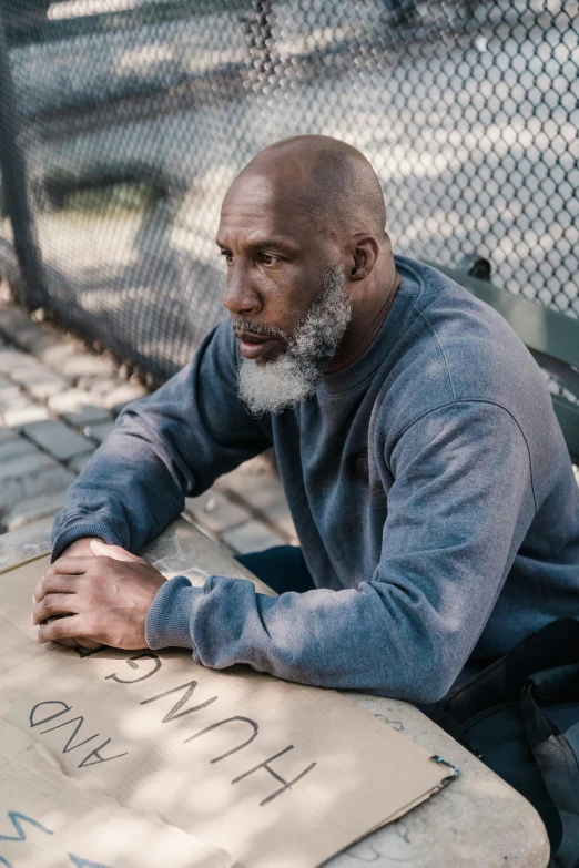 an older man is sitting down at a table