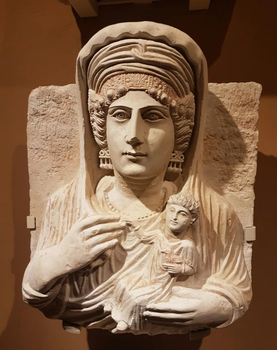 a statue of an ancient woman holding a baby