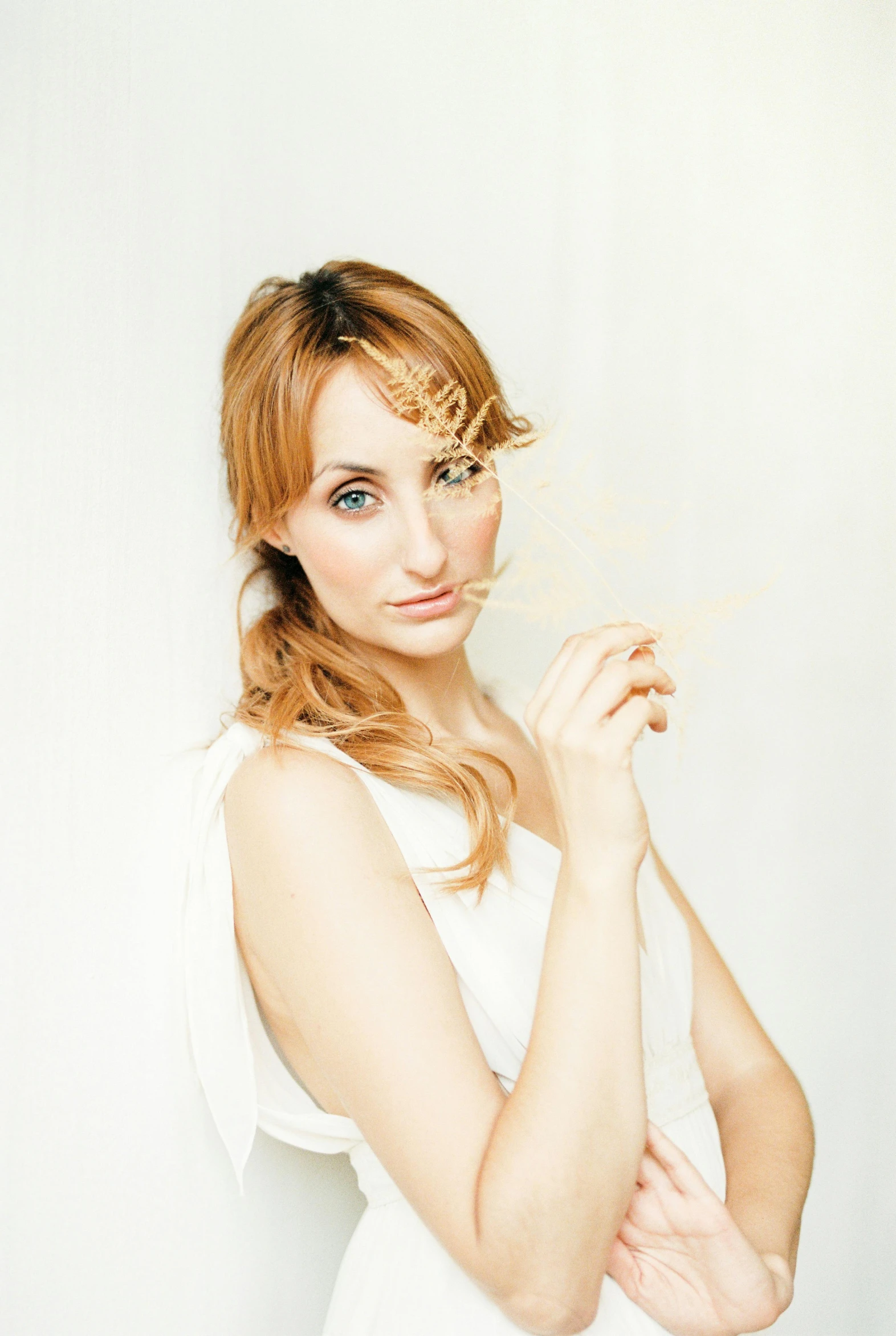 a woman posing for a po with her hair blowing in the wind