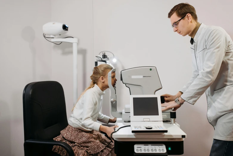 a doctor with a monitor and patient in a room