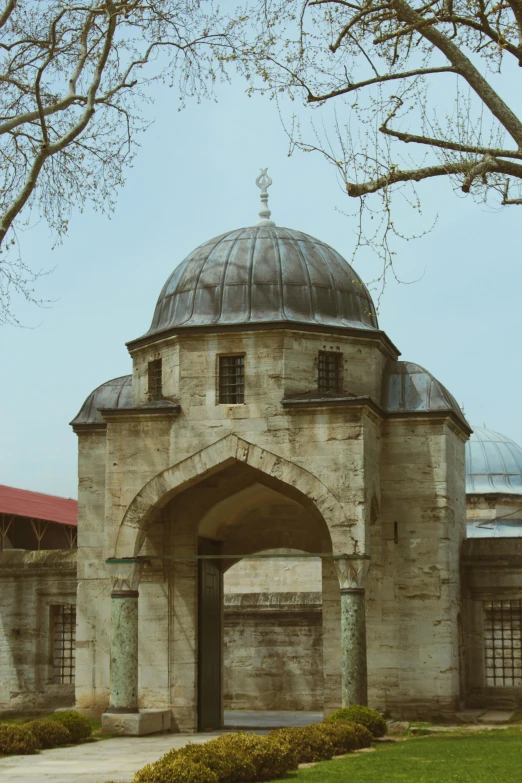 an old stone building with a black dome on top