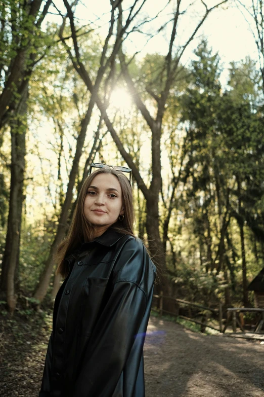 a girl in a graduation gown is standing on a path