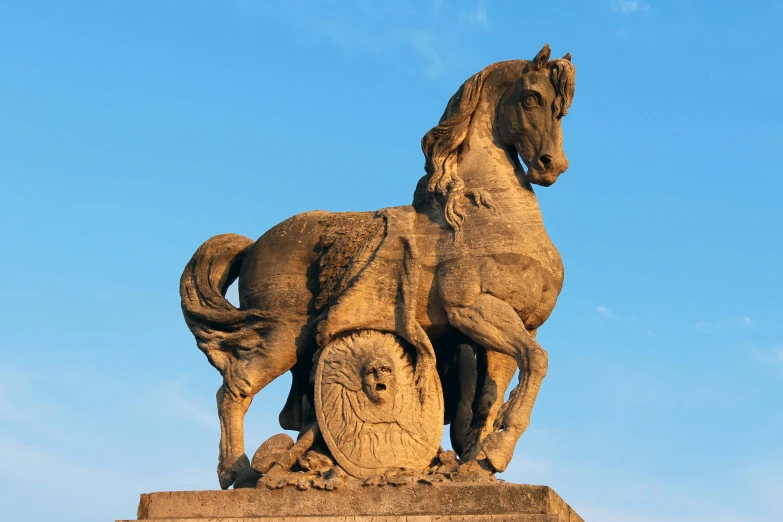 a statue is shown with blue skies above it